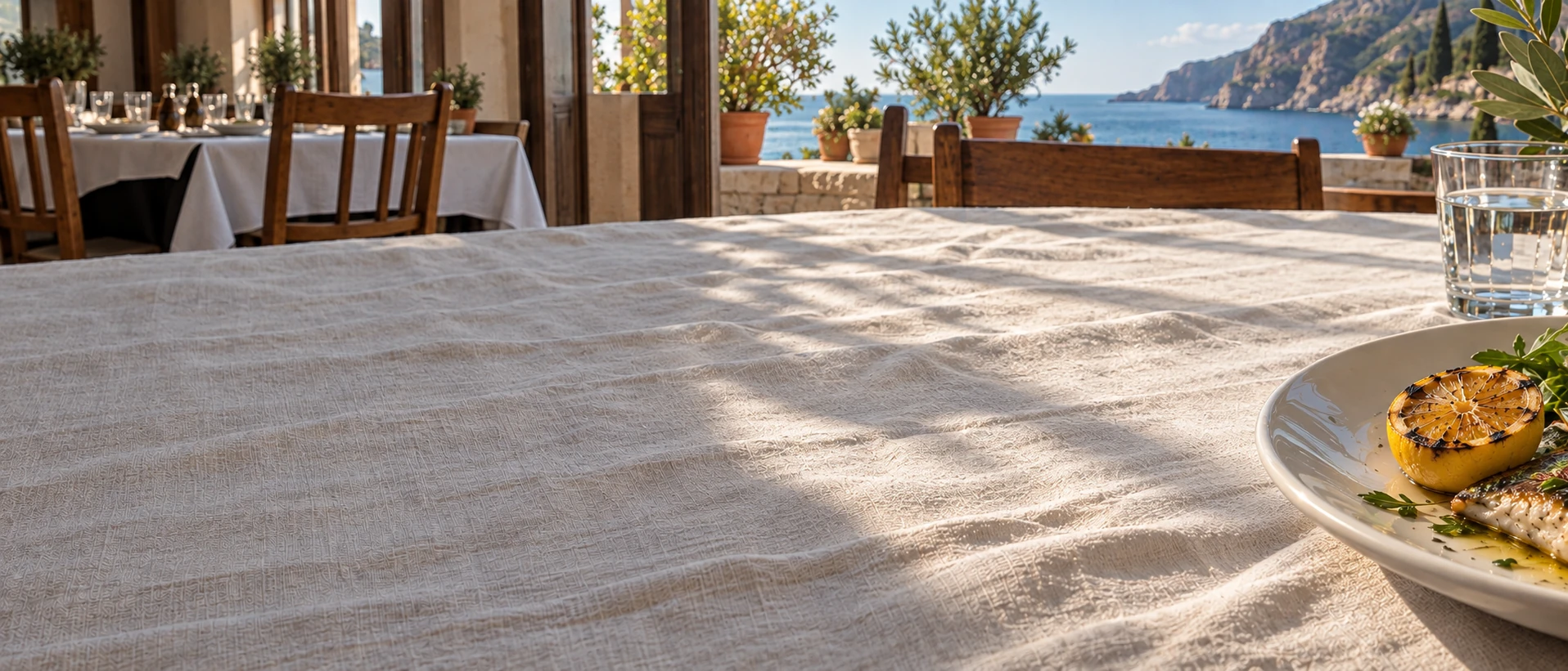 Sunlight across ivory linen. Cinematic photographic restaurant imagery with natural food and material textures.
