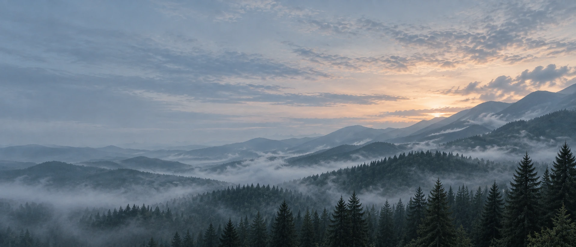 Layered mountain ridges fading into the distance. Alternate hero with copy on left.