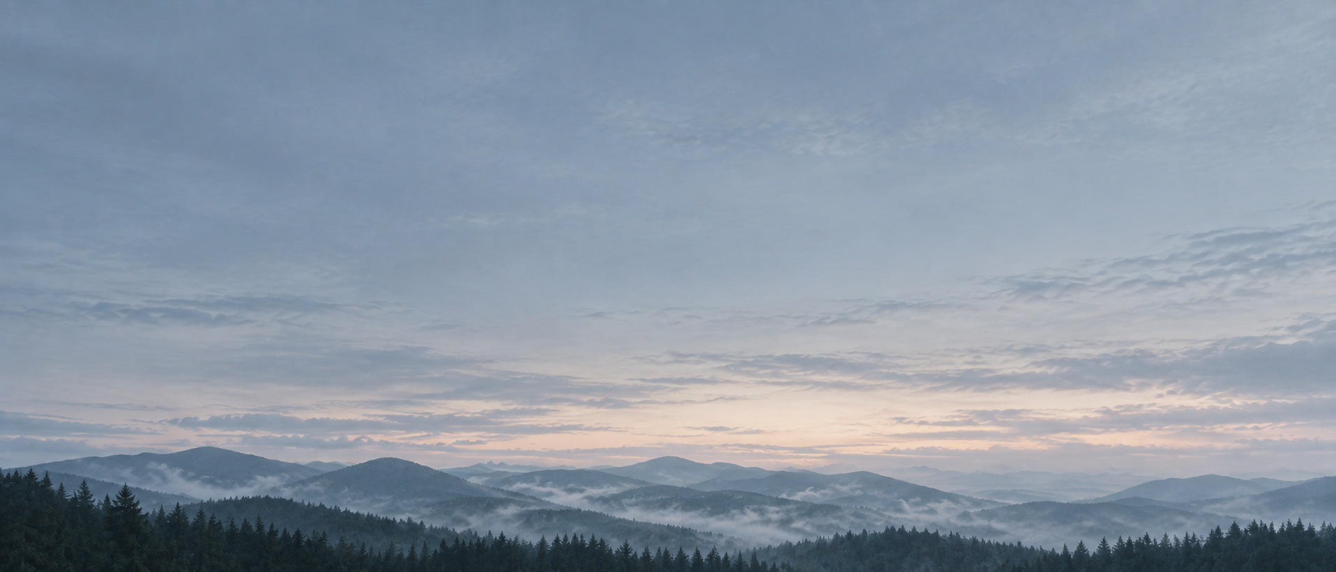 Layered mountain ridges fading into the distance. Low-detail section background or divider.