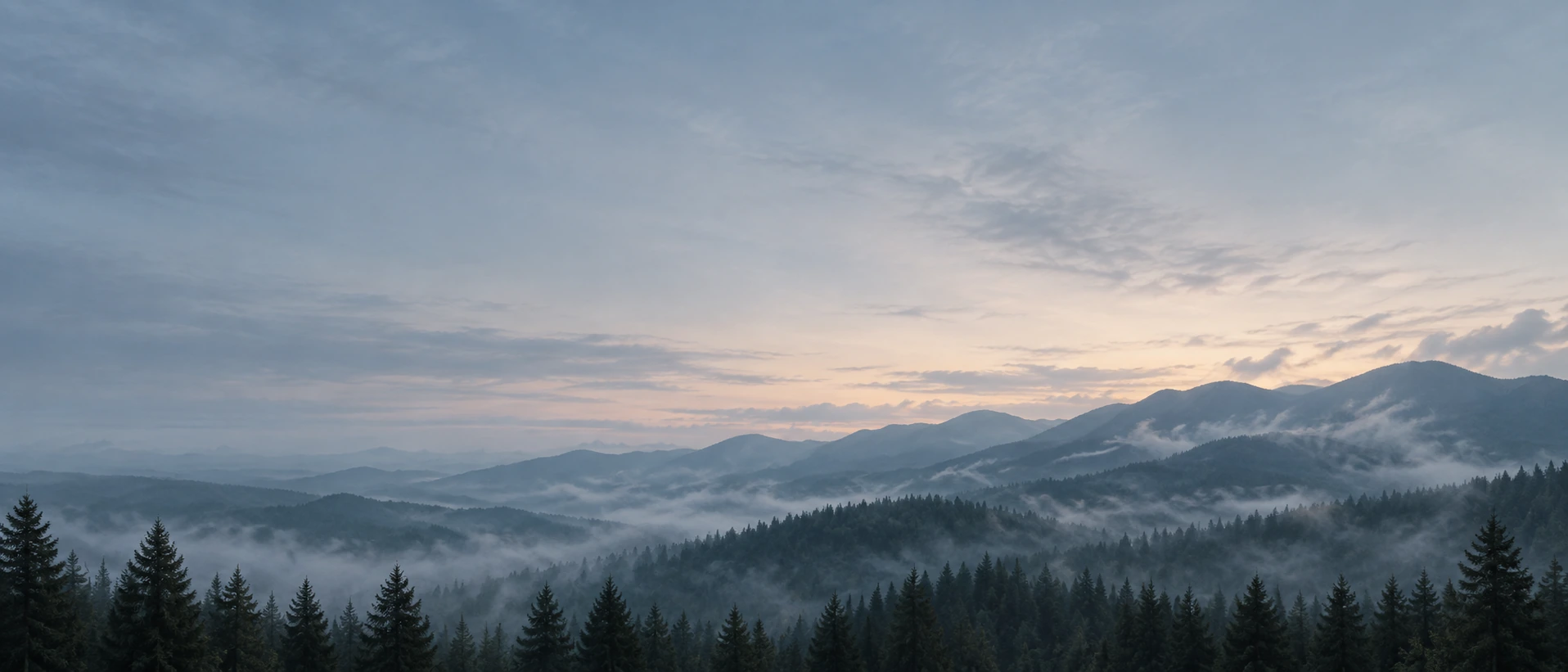 Layered mountain ridges fading into the distance. Main background.