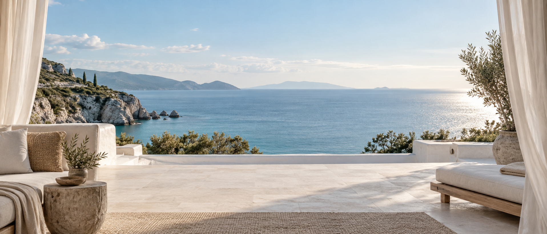 Very wide open whitewashed terrace framed by soft linen curtains at both outer edges, uninterrupted tranquil sea and sky through center, pale stone foreground for CTA.