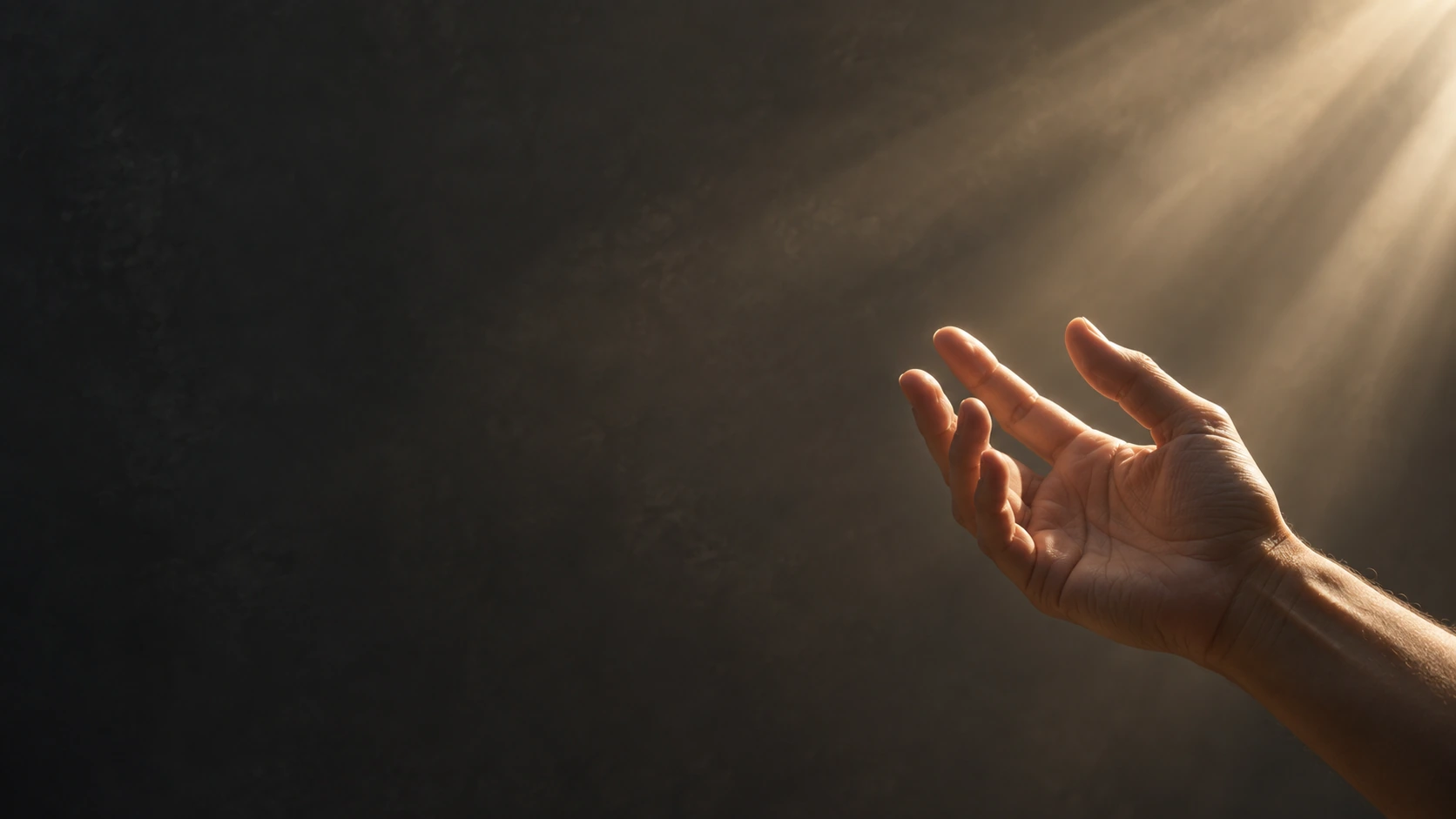 A single adult hand reaches gently into a shaft of warm daylight from the bottom right, relaxed natural fingers, calm charcoal backdrop.