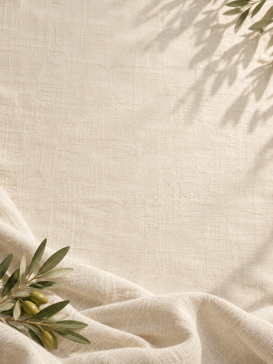 Soft linen folds and gentle olive morning light. Mobile hero background.