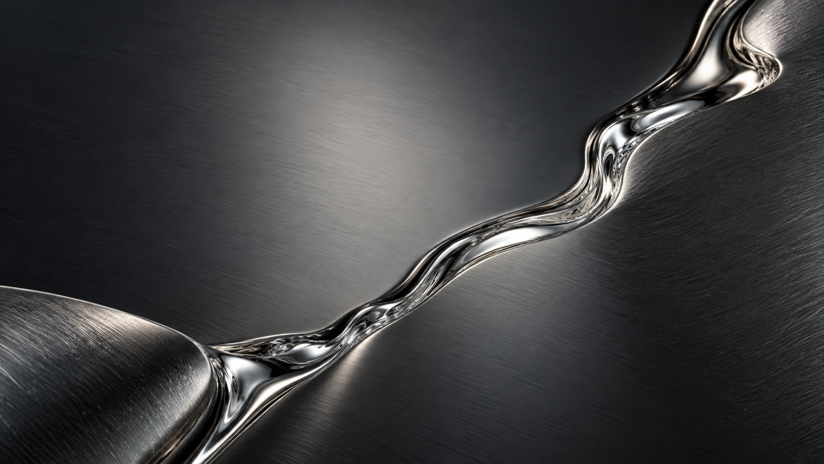 Two dark brushed metal planes meet along a narrow flowing line of liquid silver, diagonal composition and fine texture.