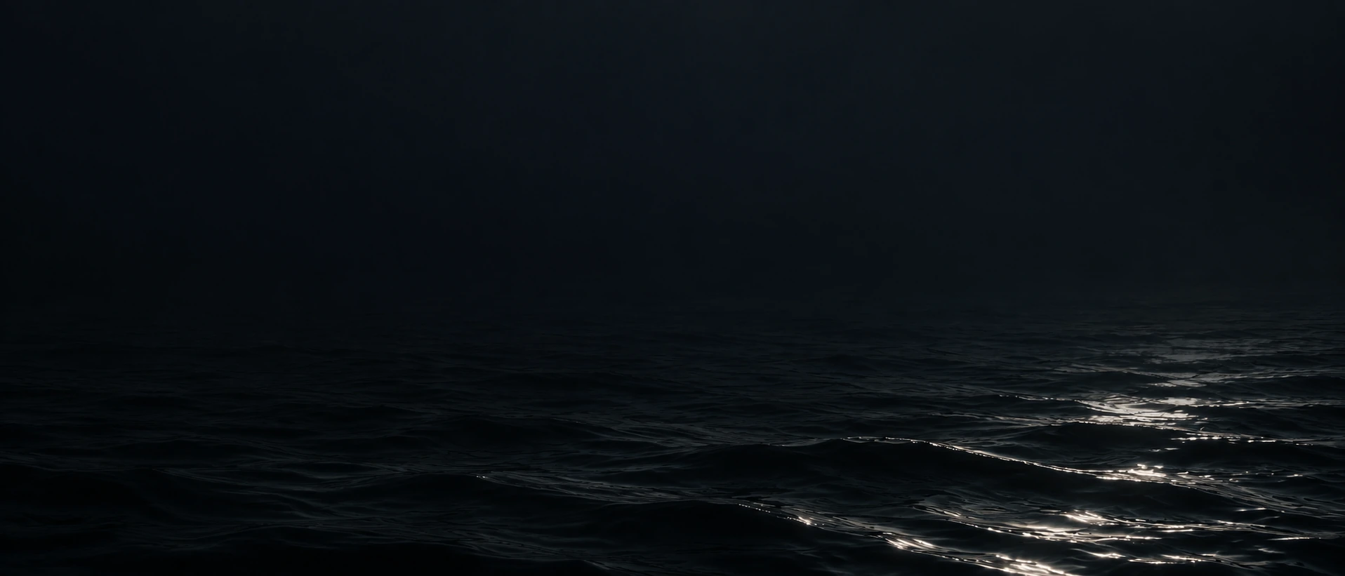 Silver moonlight falling across deep, still water. Quiet divider or quote background.