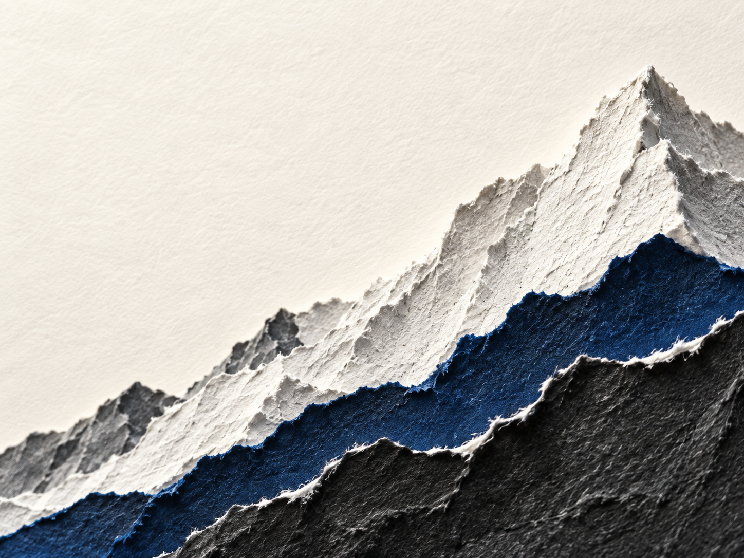 Sculptural mountain ridges cut from ivory and ultramarine paper. Material or feature detail.