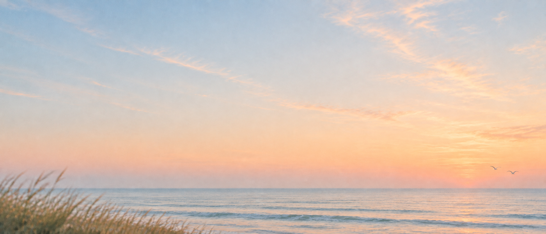 An open horizon in gentle peach-colored light. Alternate hero with copy on left.