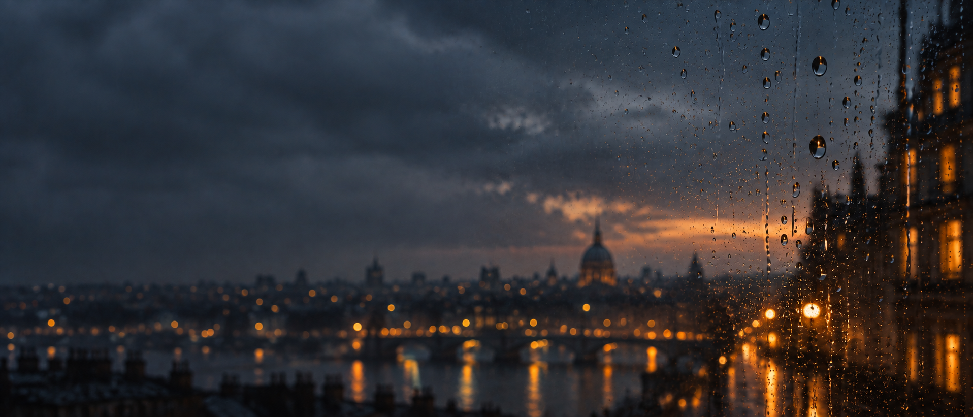 Rain-streaked glass and soft city light. Darker section background.