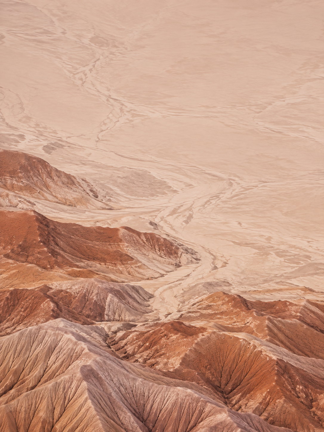 Sculpted desert lines and warm terracotta earth. Mobile hero background.