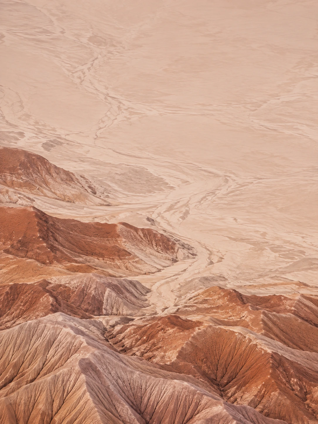 Sculpted desert lines and warm terracotta earth. Mobile hero background.